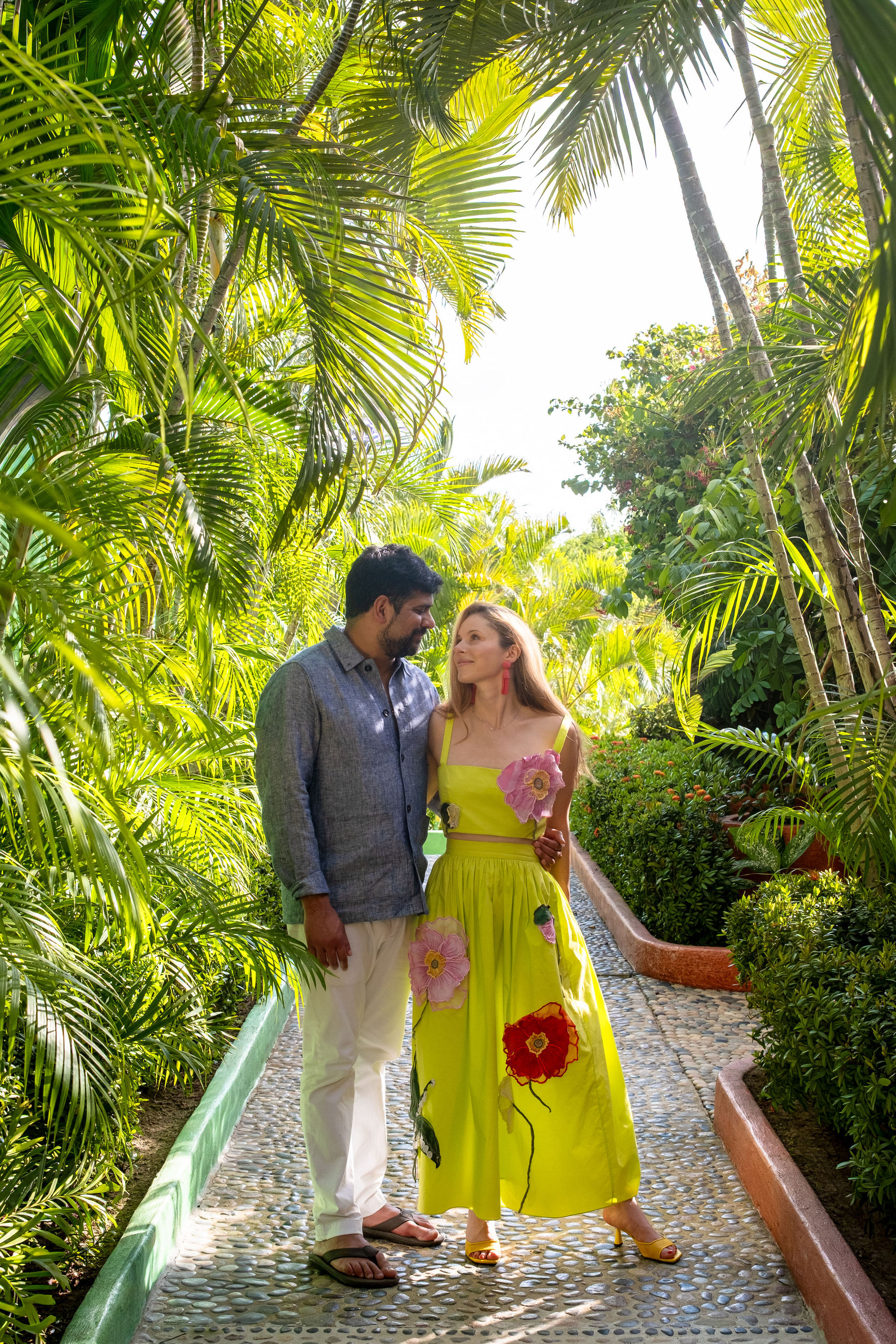Zoe and Vik embracing in greenery